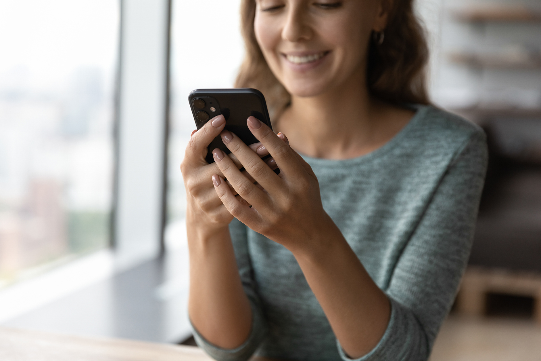 woman smiling at smartphone