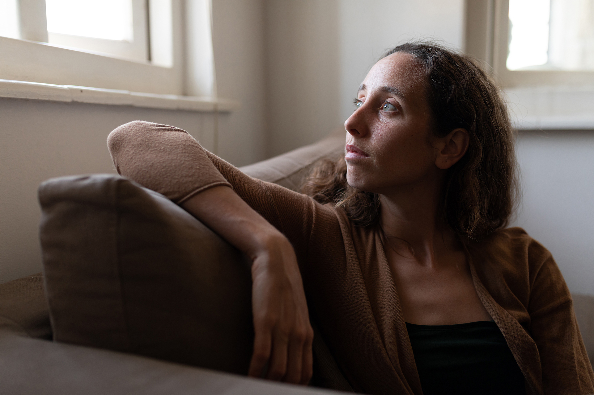 Woman staring out window deep in thought